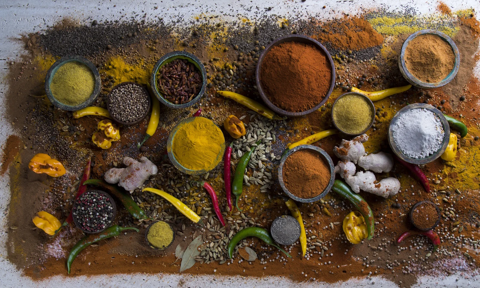 Verschiedene Gewürze sind in kleinen Schalen dargestellt.