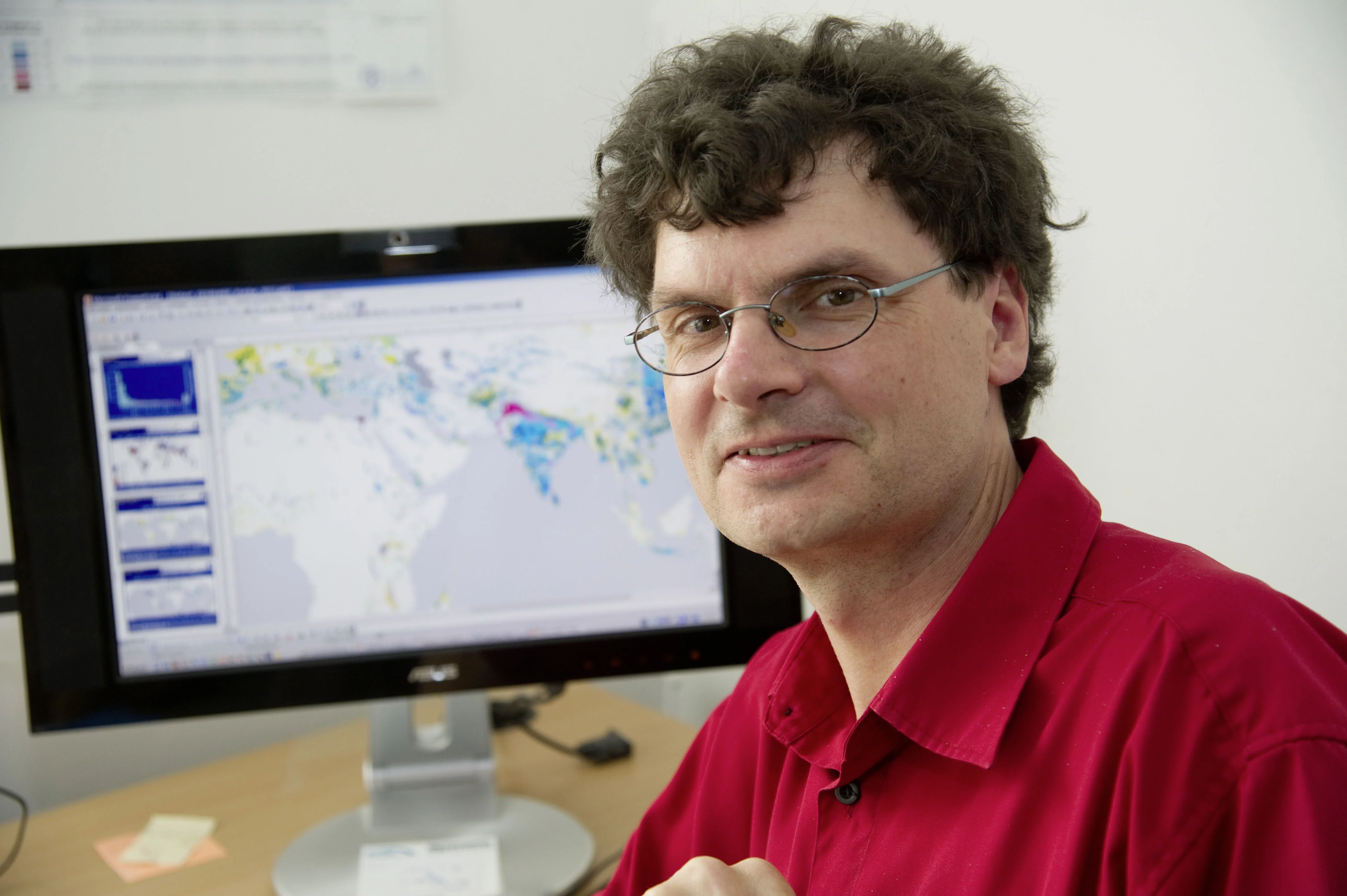 Vor der Weltkarte auf dem Bildschirm: