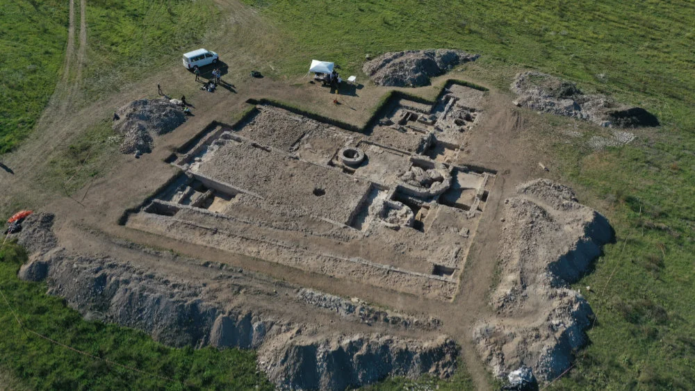Aerial shot: The two traces of wall running parallel right at the front are the twin-walled city ramparts; behind these is the aula, with the baptistery and its circular font in the middle and the atrium behind. Photo: Ostia project archives