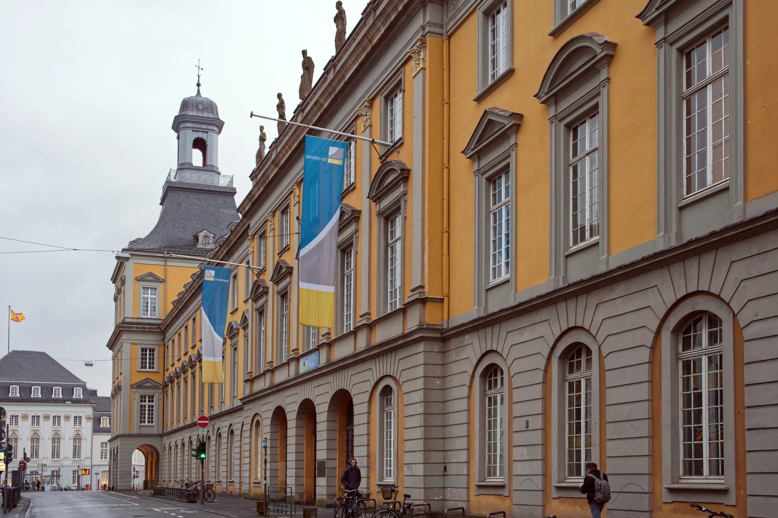 Like outside the University of Bonn’s main building, many other universities have today lowered their flags to half-staff to remember the student who was killed and the others who were injured and to mourn in solidarity with Heidelberg University.